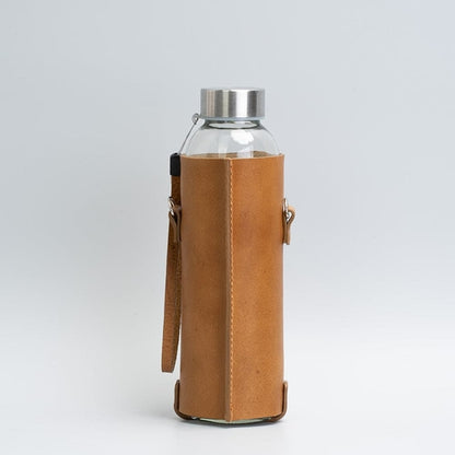 Leather water bottle holder with strap and glass bottle